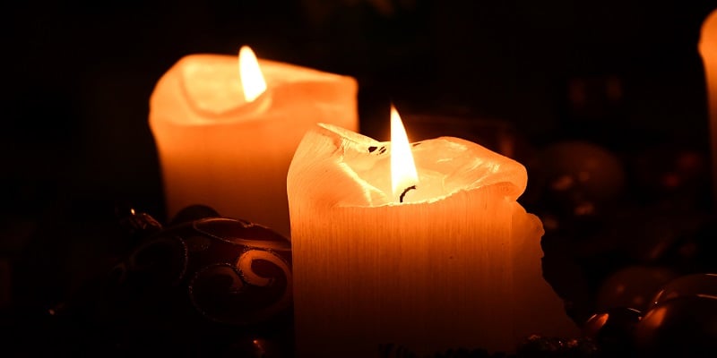 Glowing memorial candles symbolizing compassionate cremation services and remembrance